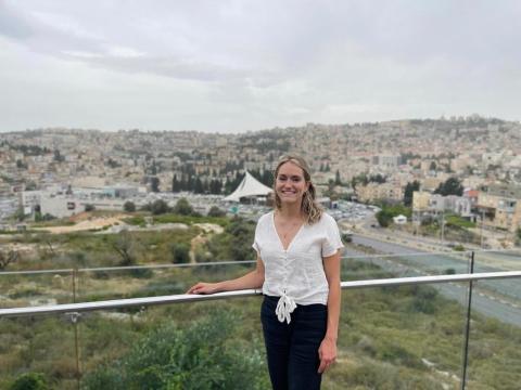 Katrina stands for a photo in front of a view of the skyline of Nazareth