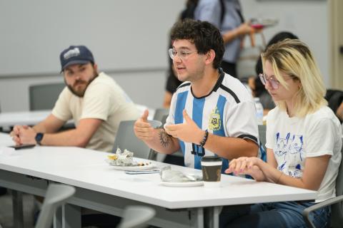 Student in the audience asks a question of the panelists.