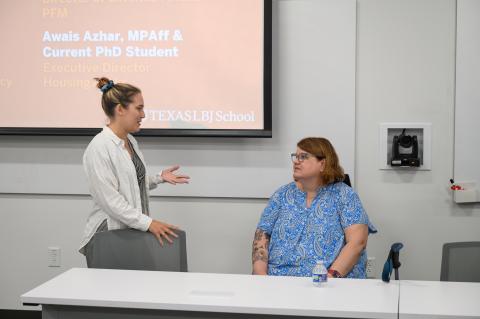 A student talks with Peggy after the panel discussion.