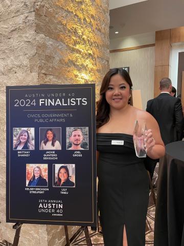 Lily standing with an award from the "Austin 40 Under 40 Awards" ceremony