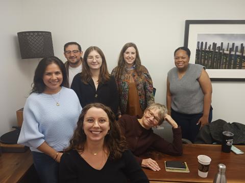 A photo of Evelyn with several students, RGK faculty and staff in a conference room.