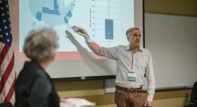 Dr. Landuyt and Dr. Rehnborg presenting data at the front of a classroom.
