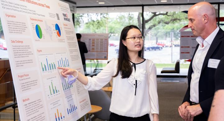 Grace Chiu sharing her poster with Dean DeShazo at the CONNECT Community Showcase