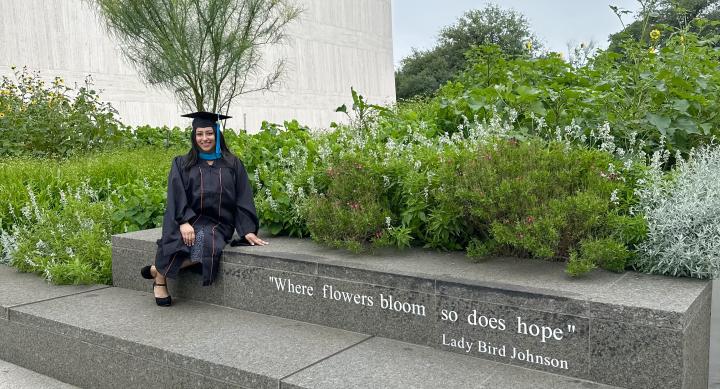 Fernanda in cap and gown outside of LBJ.